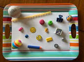 Small items arranged on a tray for a matching game