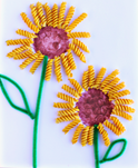 Flowers made from pasta and pipe cleaners on a sheet of paper