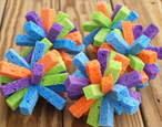Five multicolored sponges shaped into spiky balls