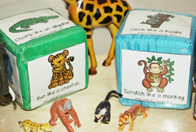 Paper cubes with pictures of zoo animals on each side