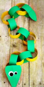 A toy snake made from green and yellow links of paper