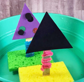Toy boats made from sponges with paper sails