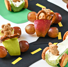 Play cars made from apples, grapes, pretzels and bear crackers